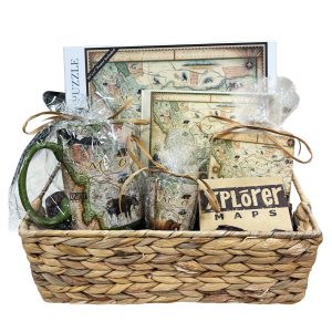 Basket with Montana-themed puzzle, mug, notecard, shot glass, gift card, and coaster.