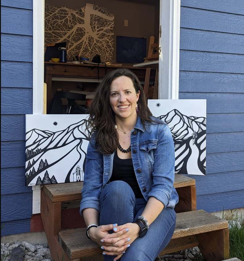image of woman on step with black and white drawings behind