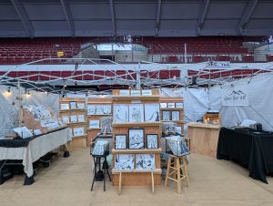 image of art booth featuring black and white drawings in various sizes and formats