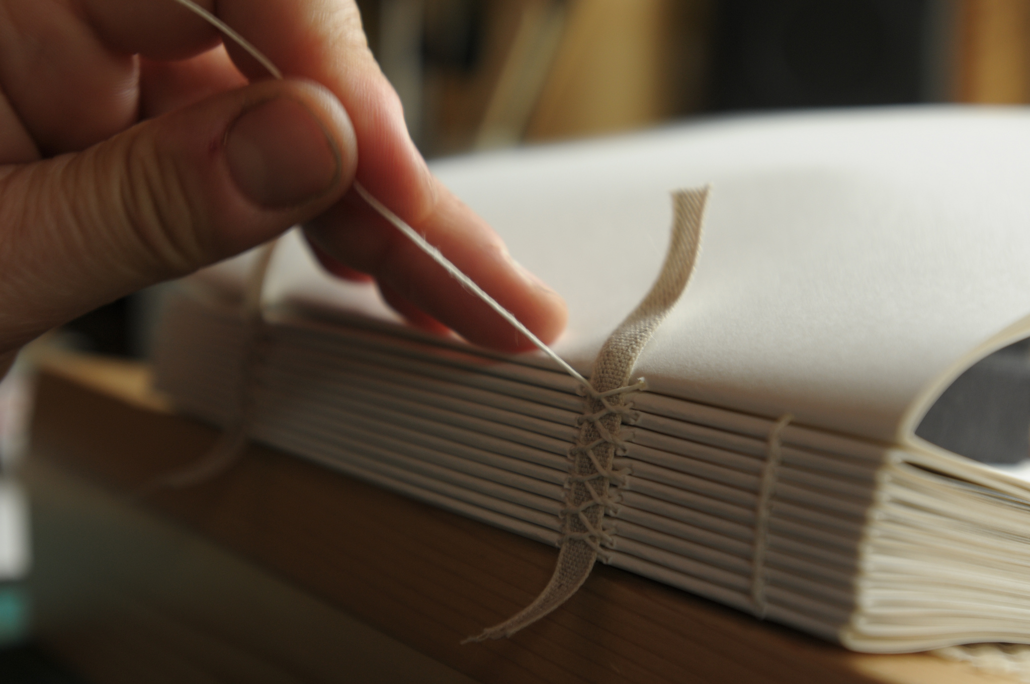 Close-up of a book being sewn