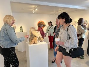 People looking at ceramic sculpture