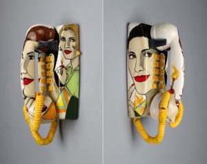 Ceramic sculpture of a wall mounted phone with illustration